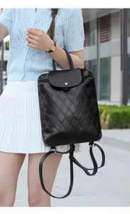 Detail of black quilted PU leather backpack featuring classic diamond stitching and metal clasp