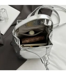 Detail view of silver bucket bag interior with large capacity and organized pockets