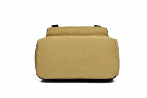 Detail view of khaki canvas backpack showing heavy-duty texture and reinforced bottom stitching