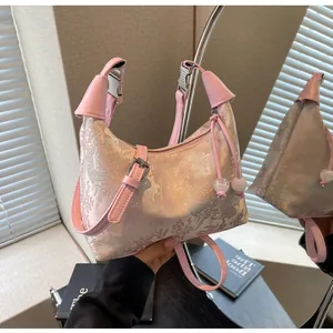Detailed embroidery on pink hobo bag with floral texture and crystal bead zipper pull