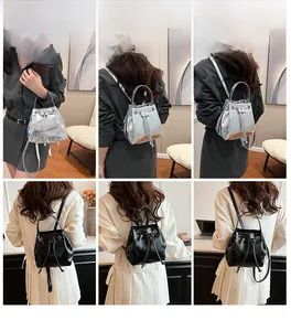 Detail shots of glossy faux leather drawstring bucket bag in silver and black colors