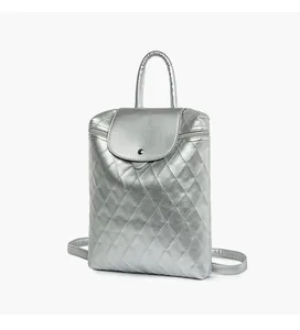 Detailed side view of silver quilted backpack with metallic finish and adjustable straps