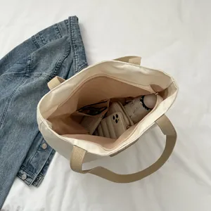 Top view of spacious canvas tote bag interior with zipper and multiple organizers