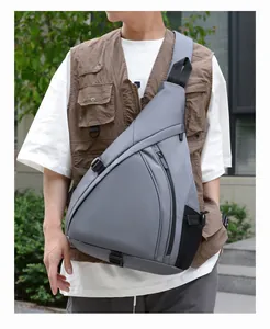 Detail of dark grey triangle chest bag with side mesh pocket for outdoor activities