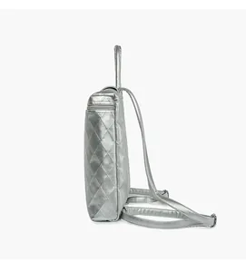 Side view of silver quilted backpack with metallic finish and slim modern profile