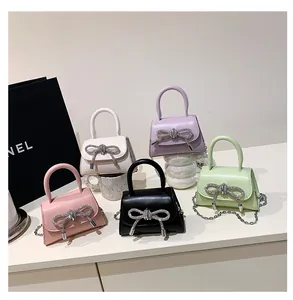 Detailed collection of mini handbags with rhinestone bows and metal chain straps