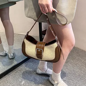 Detail of vintage baguette bag featuring woven texture and brown leather strap