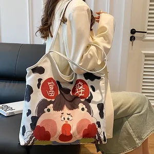 Cute cow pattern canvas tote bag with cartoon girl print shown on a model's shoulder
