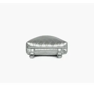Macro view of metallic silver quilted backpack bottom with shiny chrome buckle details