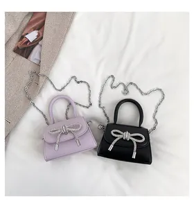 Flat lay of mini bags with rhinestone bows, metal chains and elegant ruffles