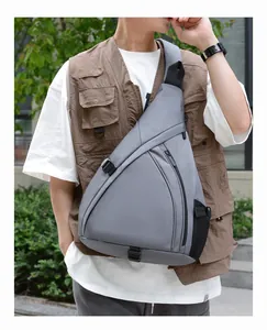 Detail of grey triangular sling bag with waterproof nylon fabric and mesh side pocket