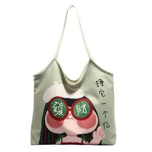 Light green canvas tote bag with cartoon girl illustration and modern art graphics