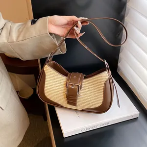 Detail of retro woven straw baguette bag featuring brown leather trim and buckle strap