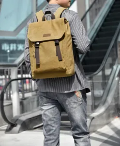 Candid urban lifestyle shot of khaki canvas flap backpack with brown nylon straps
