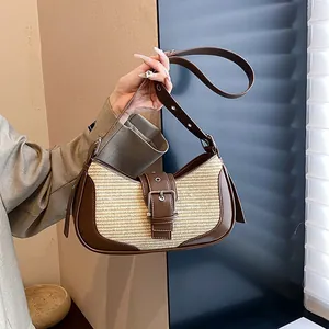 Close-up of retro mixed-media underarm bag with brown leather and beige straw weaving