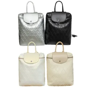 Minimalist quilted backpacks in black, white, silver, and beige with top handles