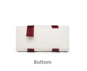 Detailed bottom view of large capacity canvas tote bag showing stitching and red straps
