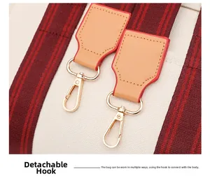 Macro shot of gold metal hooks and leather attachment on a canvas tote bag