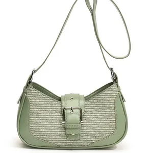Chic mint green leather and woven straw underarm bag with a stylish metal buckle