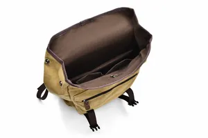 Internal structure of the canvas backpack showing multiple compartments and brown lining