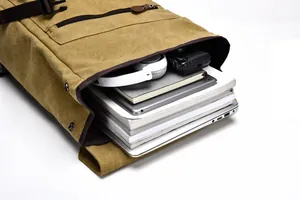 Detailed interior of vintage yellow canvas backpack showing large laptop storage capacity