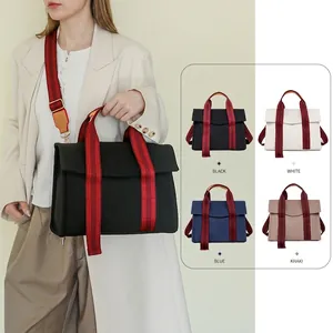 Canvas tote bag with striped wide strap and dual handles, showing multiple color options