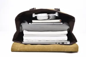 Top-down view of spacious khaki canvas backpack interior with laptop and books