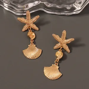 Chic gold starfish and seashell drop earrings for a stylish beach vacation look
