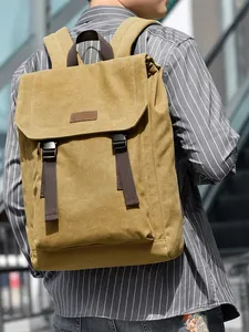 Khaki minimalist canvas backpack with flap cover and brown leather trim for daily use