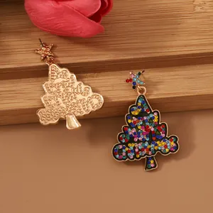 Detail of colorful rhinestone Christmas tree earrings with gold star studs and metal back