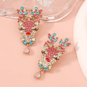 Detail of reindeer stud earrings with colorful rhinestones and pink teardrop charm