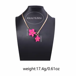 Detail of pink flower pendant necklace with dimensions 43cm length and 3.3cm flower size
