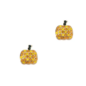 Close-up of gold-plated pumpkin stud earrings with orange and green sparkling crystals