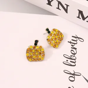 Exquisite pumpkin stud earrings with yellow crystals and green leaves in gold finish