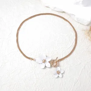 Elegant gold snake chain necklace with white flower charms and stylish OT toggle clasp