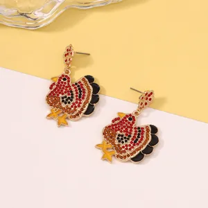 Detailed view of turkey earrings with multicolored crystals and gold-plated alloy finish