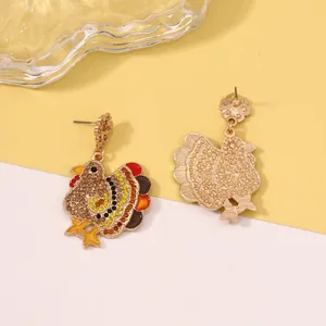 Macro detail of rhinestone-encrusted turkey drop earrings with gold-tone metal backing