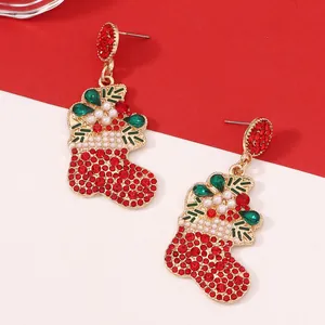 Close-up of Christmas stocking pendant earrings with red and green rhinestones