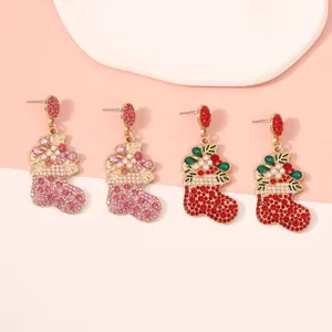 Detailed view of Christmas stocking earrings with rhinestones and faux pearls