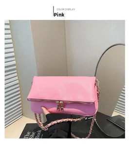 Detail of pink lychee textured leather crossbody bag with double gold zippers and chain strap