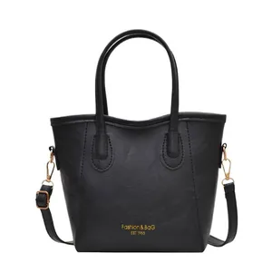 Classic black leather bucket bag with gold lettering and adjustable shoulder strap