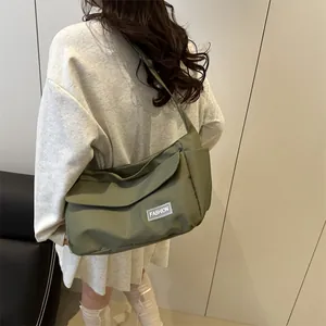 Olive green utility messenger bag with side pockets and fashion patch for commuting