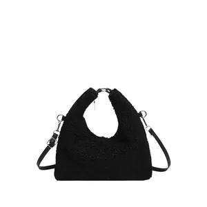 Minimalist black faux shearling crescent shoulder bag with detachable strap for women