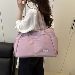 Purple large capacity canvas tote bag with fashion label shown on a female model