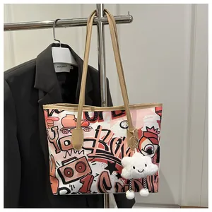 Pink canvas tote bag with vibrant graffiti prints and a soft plush cloud pendant charm