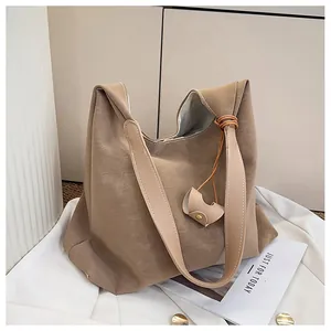 Macro shot of khaki hobo tote bag with aged PU leather texture and detachable buckle accessory