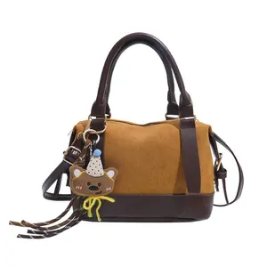 Retro two-tone frosted leather pillow bag with cute bear charm and top handle
