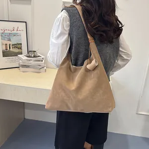 Minimalist khaki leather tote bag for women with wide shoulder strap and spacious design