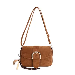 Minimalist caramel suede crossbody bag with gold round buckle and tassel charm