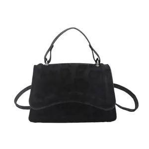Large black leopard print tote bag with round top handle and long shoulder strap